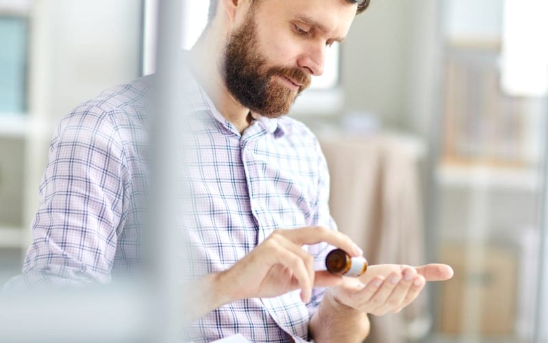 Man Taking Fadogia Agrestis Supplement